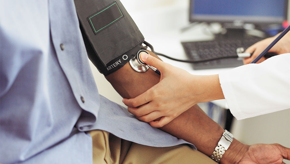 Provider measuring patient's blood pressure