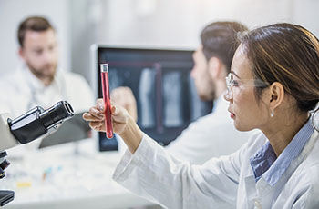 BIDMC Hematologist holding a test tube