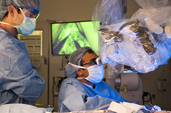BIDMC's Dhruv Singhal, MD performs surgery on a patient with his colleague looking on.