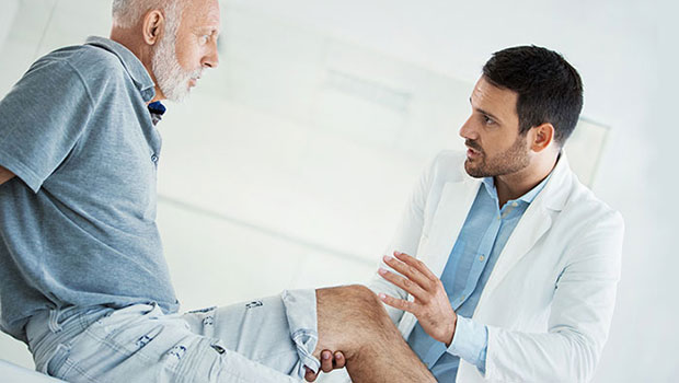 BIDMC doctor holding patient's knee