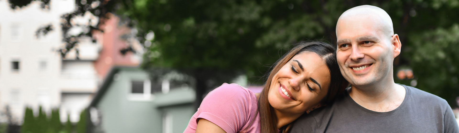 A male cancer patient smiling with his female spouse