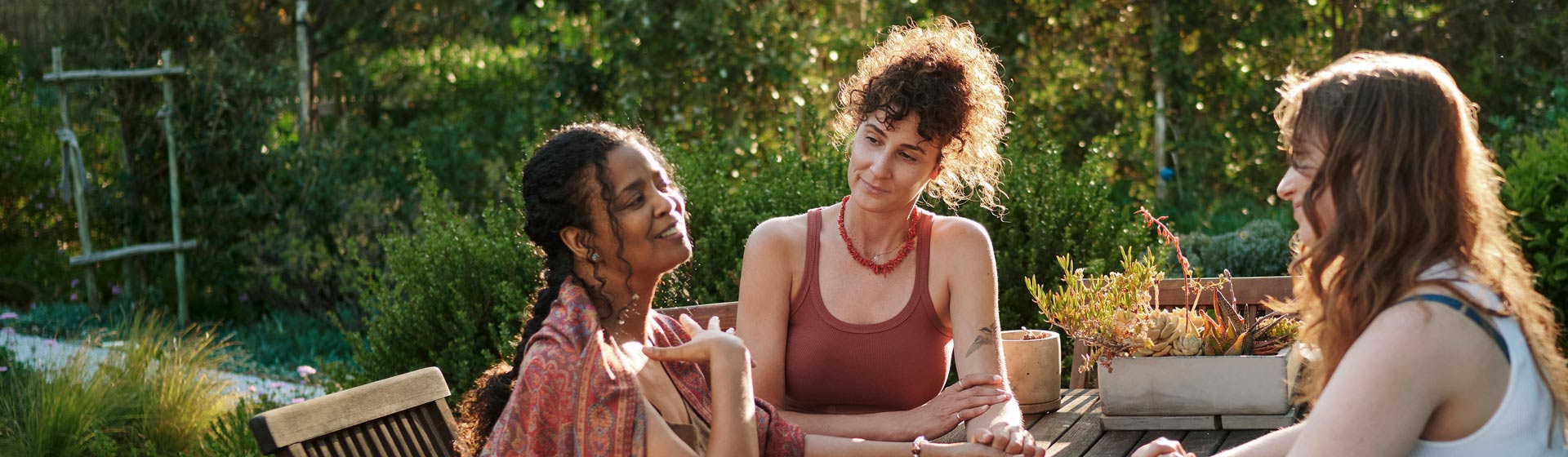 Girls talking outside at a table