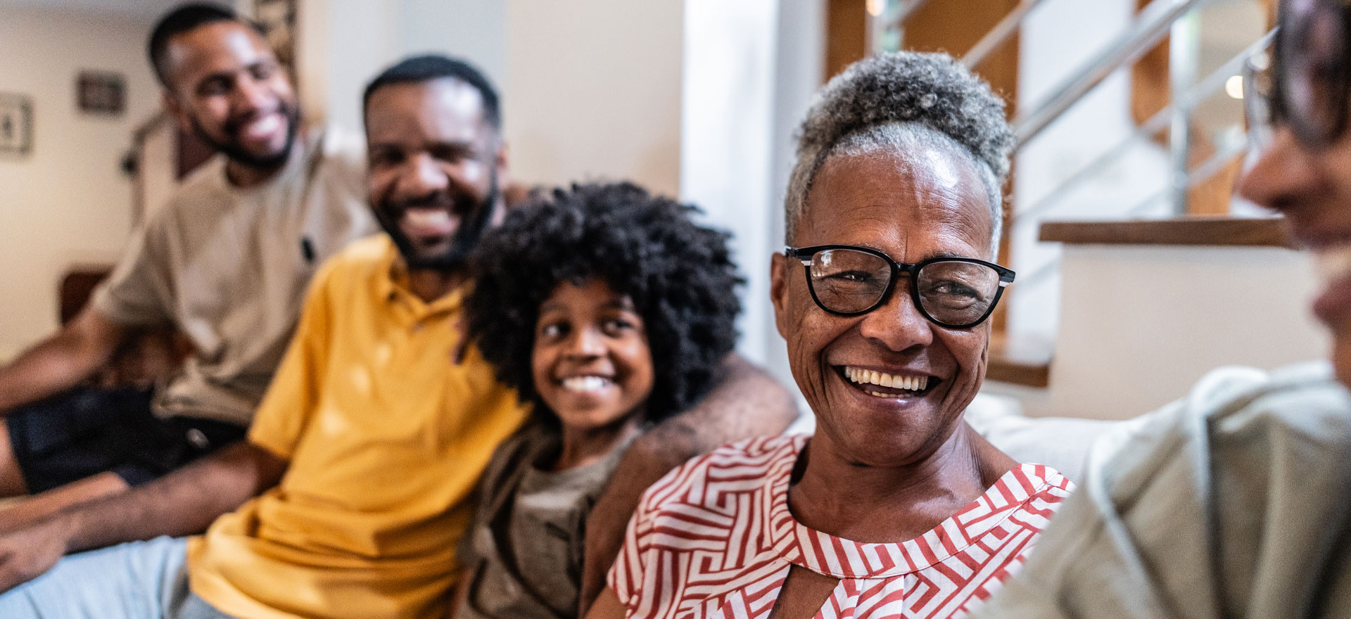 Family of many ages laughs in their living room together