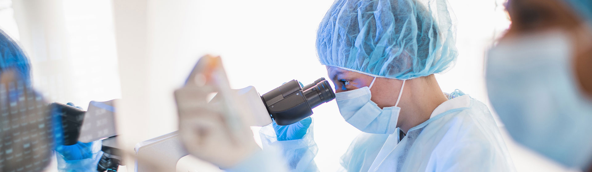 Woman looking through a microscope