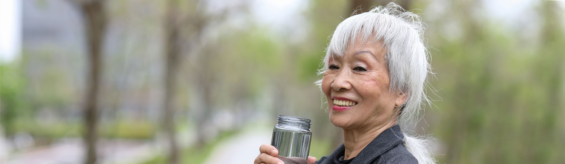 Woman drinking water while on a run