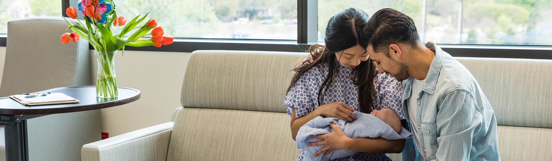 A couple holding a newborn at the hospital