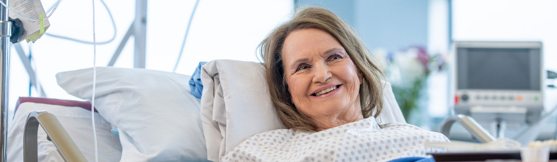Woman smiling in her hospital bed