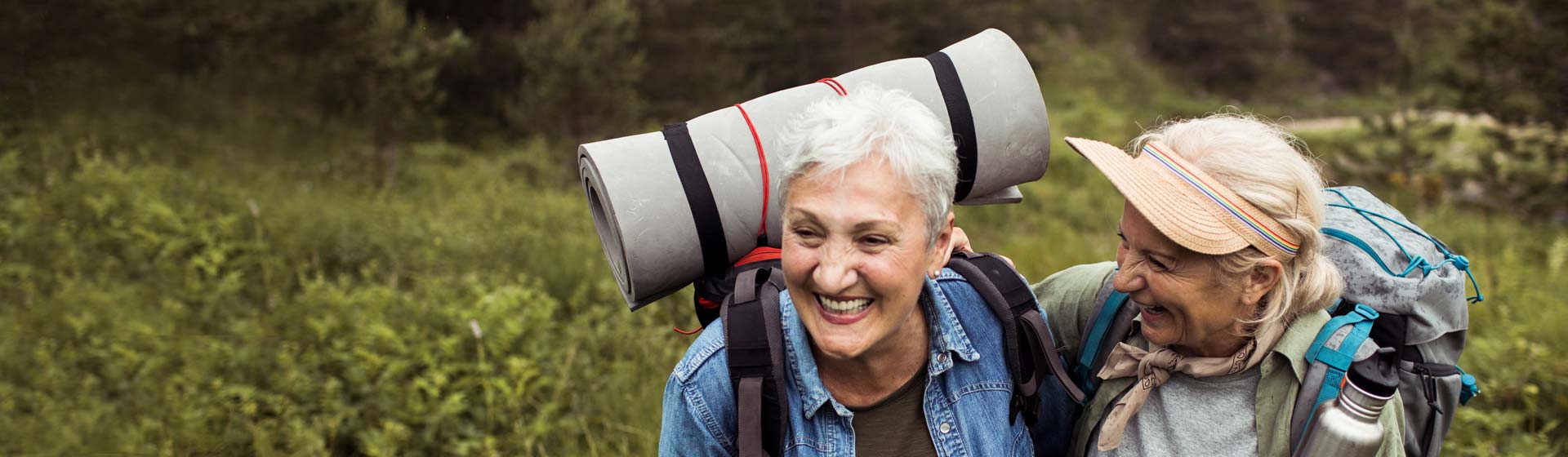 Two women laughing while on a hike