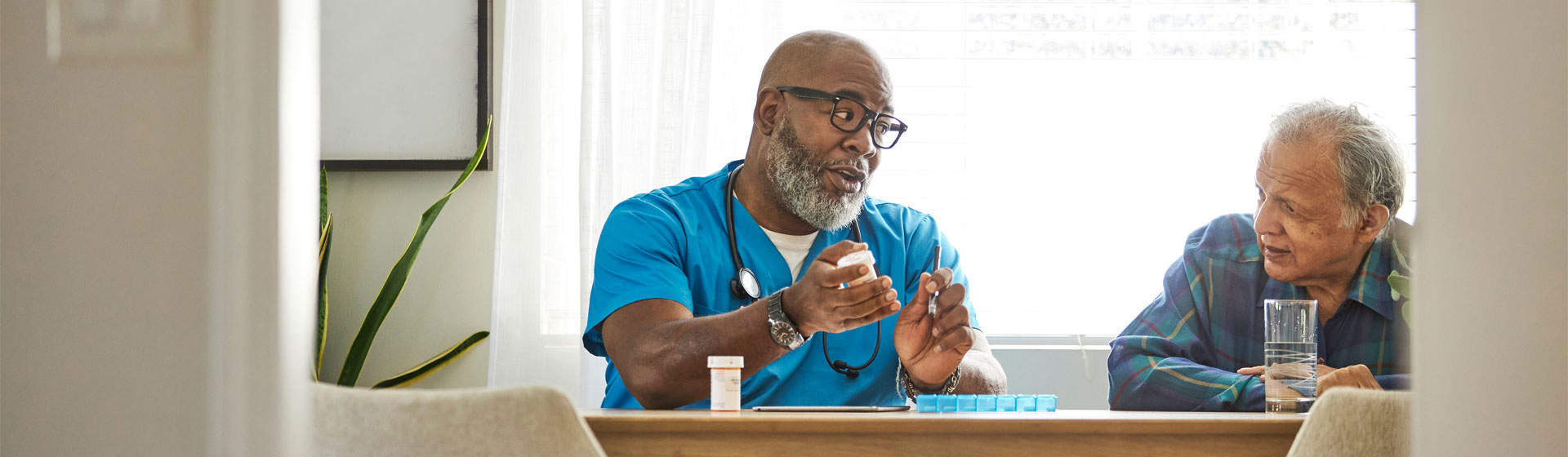 A male nurse talking to an elderly patient