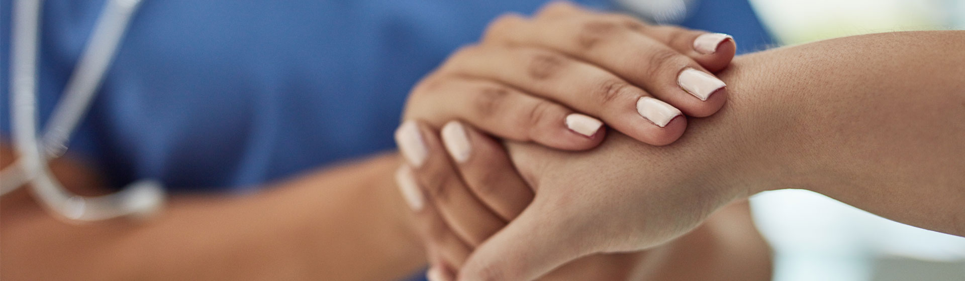 A medical staff holding hands with a patient