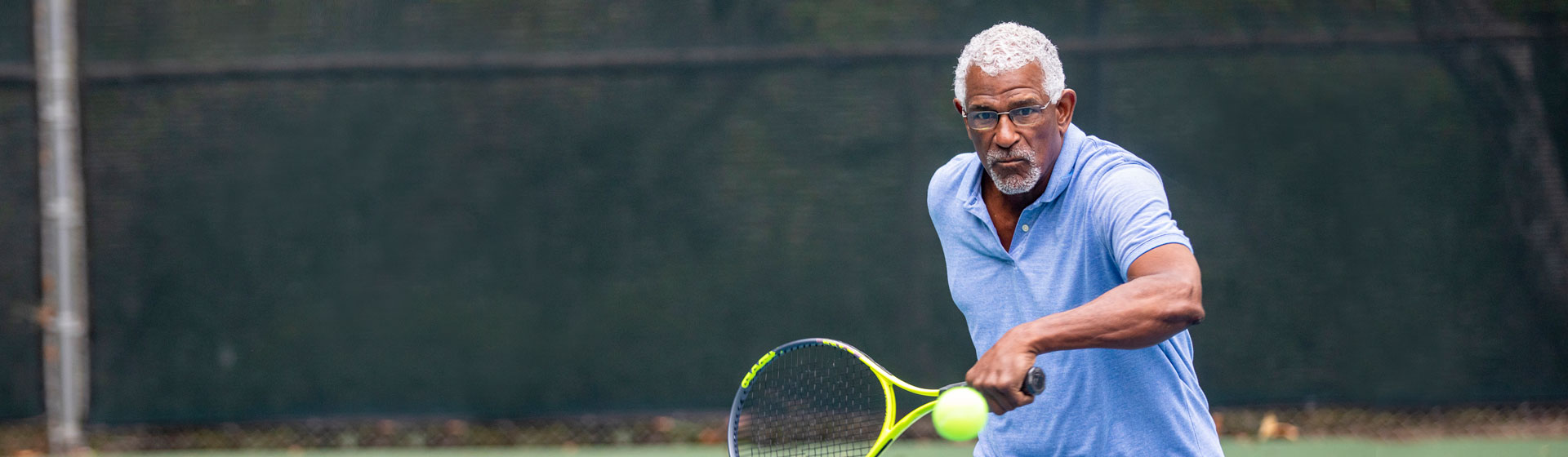 Middle-Aged Man Playing Tennis