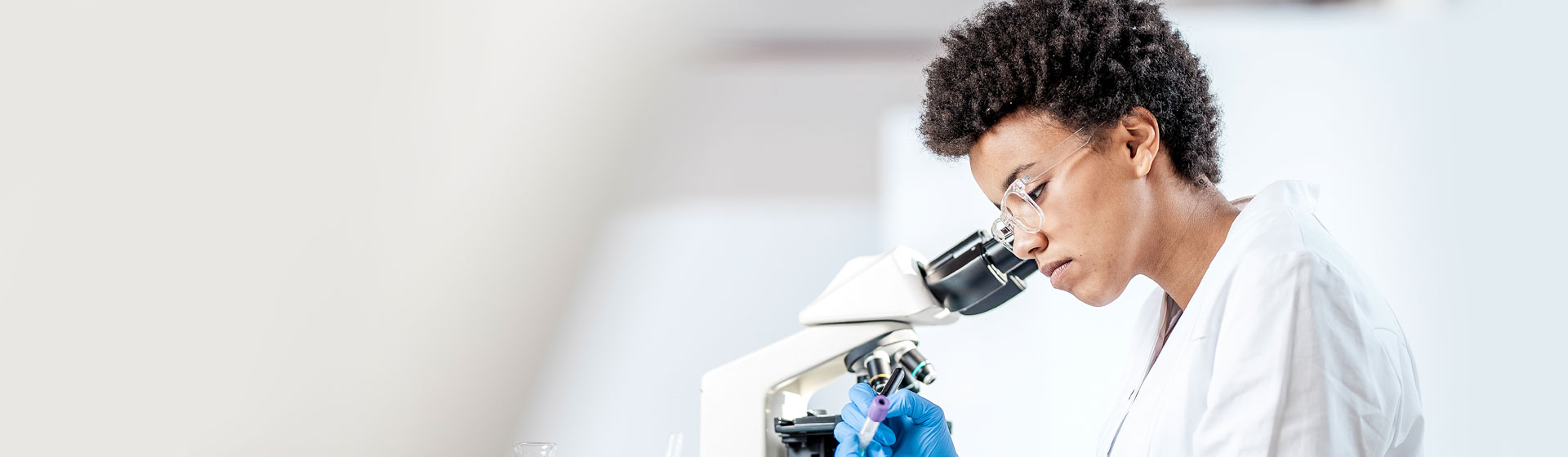 Researcher at a microscope
