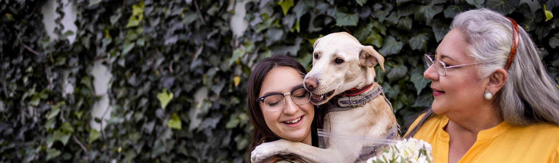 A woman and her daughter with their dog