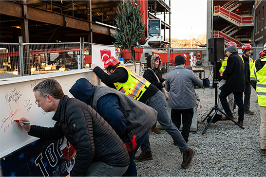 BILH staff and workers signing the building