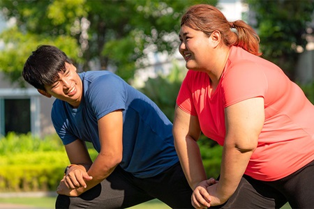 Friends stretch as they exercise together