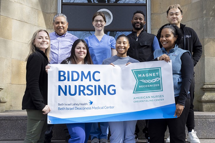 Nursing staff and students holding a BIDMC Nursing Magnet Sign