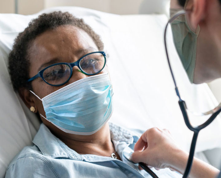 Masked female patient with doctor