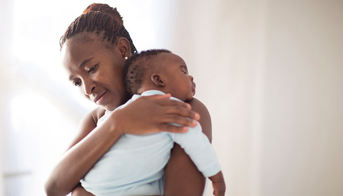 Mother Holding Sleeping Infant