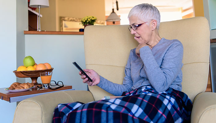 Cancer patient using mobile device at home
