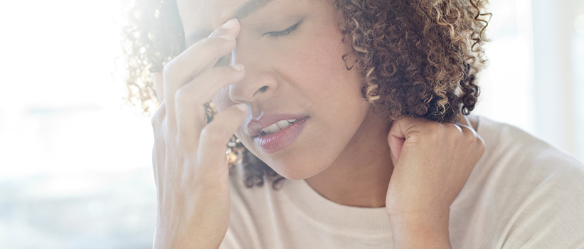 Woman experiencing a migraine