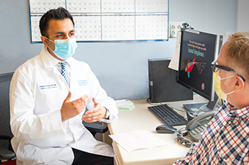 Dr. Usman Tahir talking to a patient