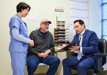 Colorectal surgeons going over treatment with a patient