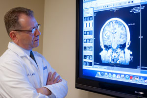 Ronnie L. Alterman, MD of BIDMC reviewing a brain scan