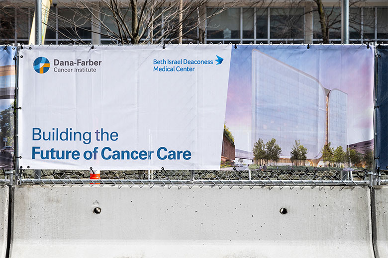 Banner sign on fence for new cancer hospital, part of the Dana-Farber Beth Israel Deaconess Cancer Collaboration