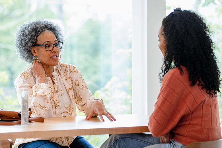 Two women talking at a table
