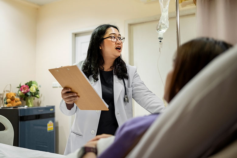 Doctor talking to patient at a hospital