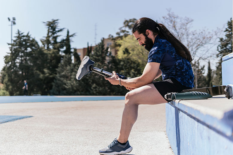 Man putting an amputee leg on