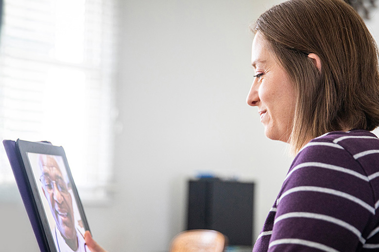 Adult woman connecting with a virtual provider on her laptop during a virtual primary care appointment