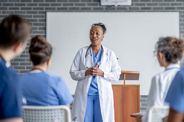 Faculty member speaks to medical students in classroom