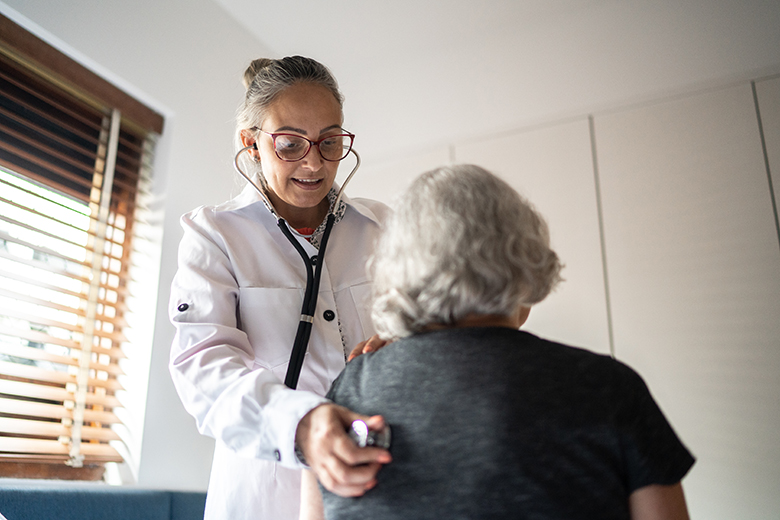 Female doctor listening to patient's heart