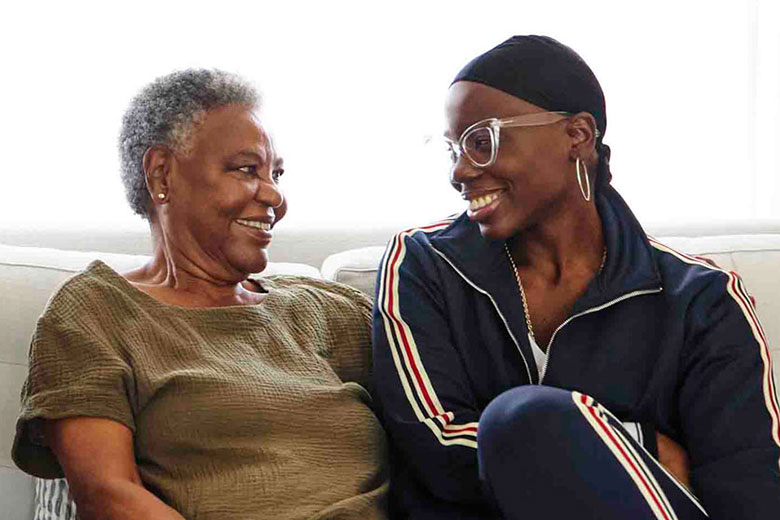 Female cancer patient smiling with mother