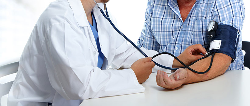 doctor checking patient's blood pressure
