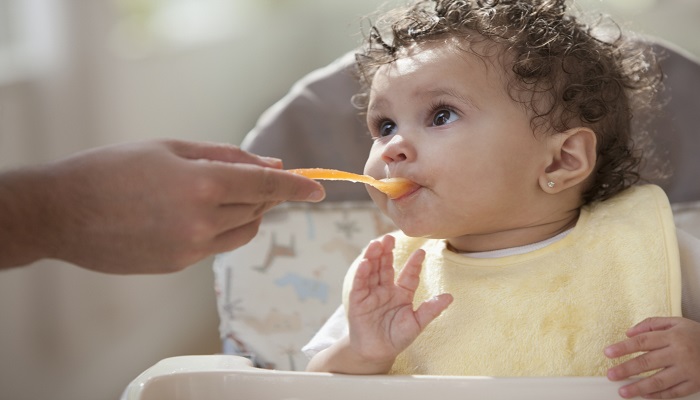 Babies typically start on solid foods somewhere between the ages of 4-6 months Baby girl tries first solid foods